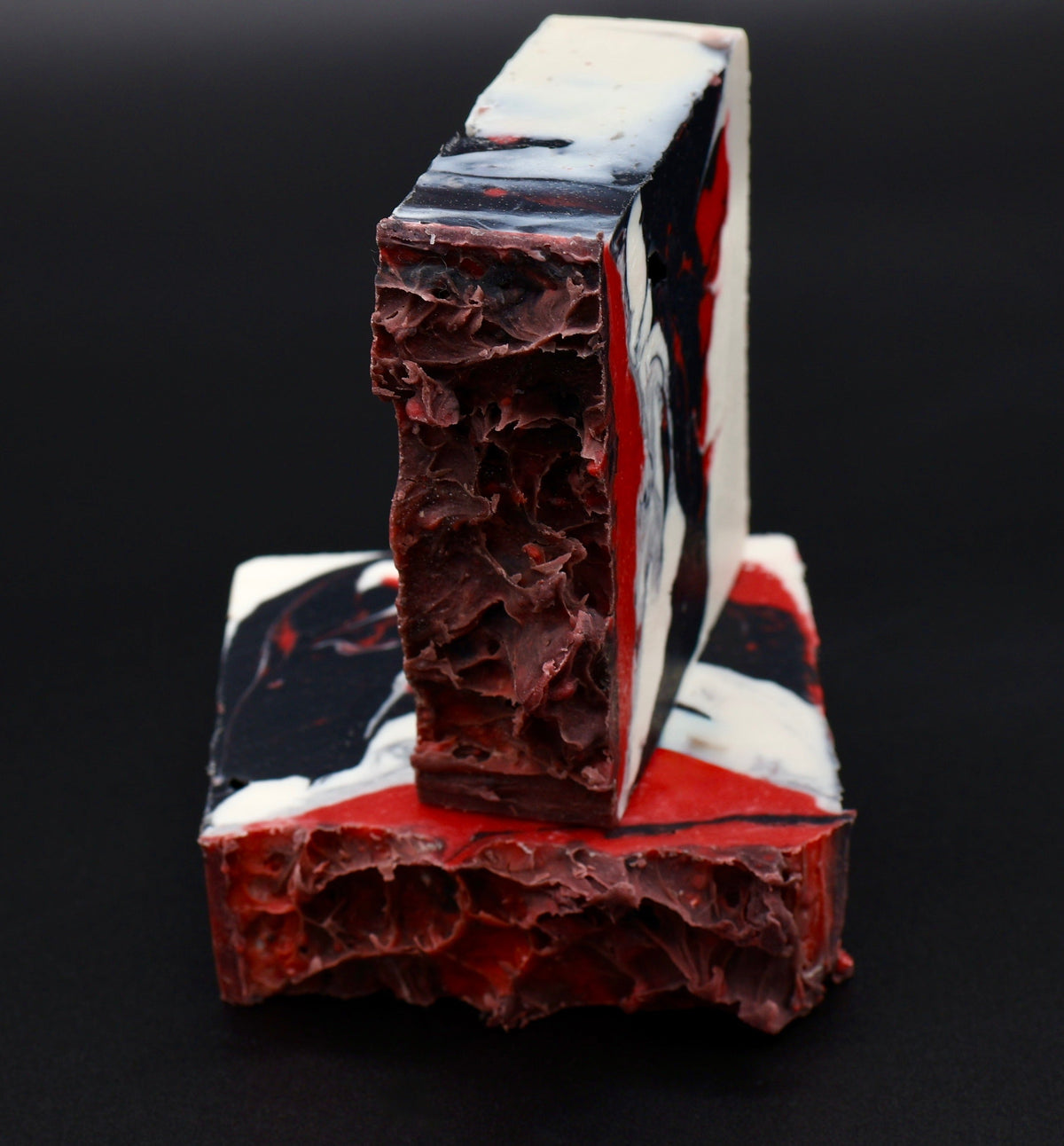 Voided Flesh soap front view showing crimson and black marble swirl pattern