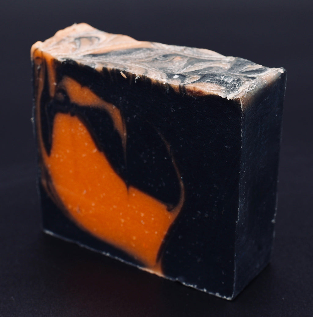 Tick-O-Treat soap angled view showing dramatic black body with orange flame swirl