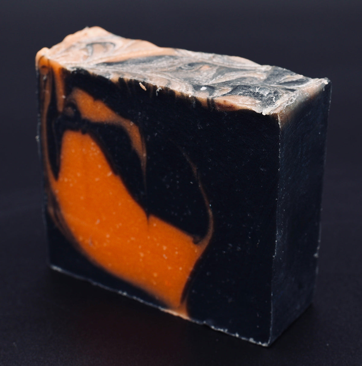 Tick-O-Treat soap angled view showing dramatic black body with orange flame swirl