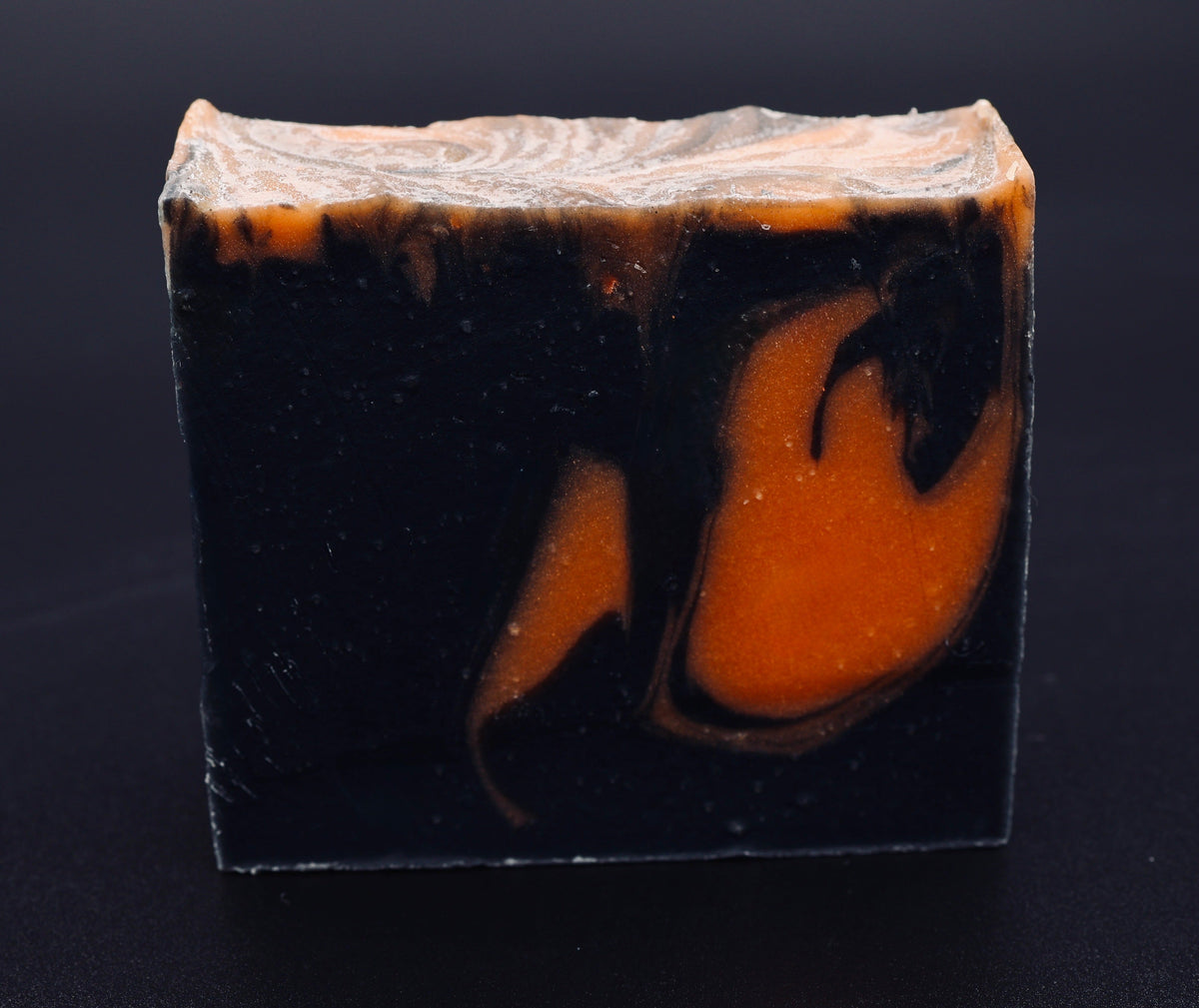 Tick-O-Treat soap front view showing bold black and orange swirl design