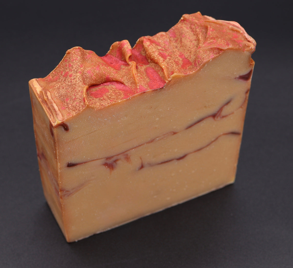 Fall Harvest soap angled view showing copper shimmer top and layered swirl pattern