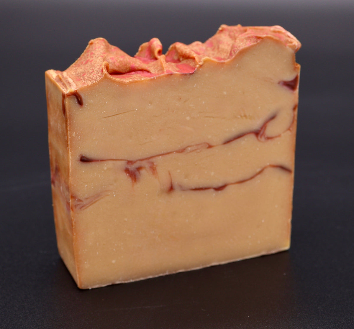 Fall Harvest soap side profile showing golden body with deep red swirl layers